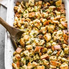 a casserole dish filled with stuffing and vegetables