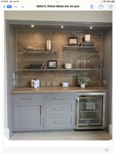 a kitchen with gray cabinets and shelves filled with wine glasses