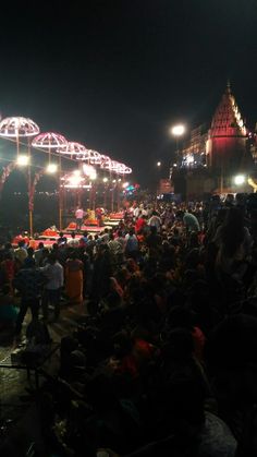 many people are gathered in the street at night