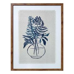 a blue and white plant in a glass vase on a linen background with wood frame