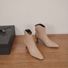 Looking for the perfect pair of shoes to transition from summer to fall? These nude ankle boots are just what you need! Made with a square toe and 2'' heel. they are both stylish and comfortable. The leather material is also perfect for pairing with any outfit.  Upper: Leather Lining: Leather Outsole: TPR Toe: Square Toe Heel: 7cm/2.8'' Closure: Zip Color: Nude. Burgundy is_handmade: Yes The above measurement is based on size 6. with one size larger. 0.5cm wider. Chic Medium Width Heeled Boots With Square Toe, Elegant Heeled Ankle Boots For Spring, Elegant Low Heel Heeled Boots For Spring, Elegant Spring Ankle Heeled Boots, Trendy Beige Square Toe Heels, Elegant Beige Mid-calf Boots For Spring, Elegant Block Heel Boots For Spring, Trendy Beige Boots With Reinforced Heel, Chic Cream Pointed Toe Mid-calf Boots