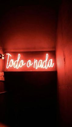 a red neon sign that says to do or nadda on the side of a wall