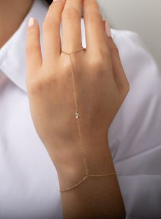 Beautifully handcrafted 14k yellow gold pear shape bezel diamond hand chain bracelet with a front segment of the bezel that connects to your finger. Uber chic and modern, this jewelry will be your new obsession! Bracelet Length: 6"-7" Bezel Chain Length: approx. 4" Diamond weight: approx. 0.12ctw Diamond size: 4mm x 6mm Size of Ring: 7 Ships in 4-7 business days Rush order ships in 2-5 business days Comes gift ready in a custom Zoe Lev jewelry box Bracelets Gold Bracelets Gold Simple For Women, Hand Chain Jewelry, Finger Bracelets, Hand Chain Bracelet, Ring Bracelet Chain, Gold Water, Hand Bracelet, Classy Jewelry, Fancy Jewellery