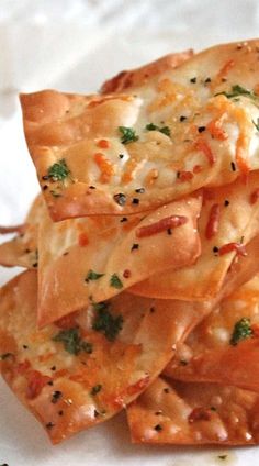 a pile of cheesy tortilla shells on a white plate