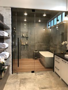 a bathroom with a large glass shower door