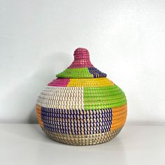 a colorful basket sitting on top of a white table