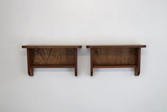 two wooden shelves on the wall next to each other