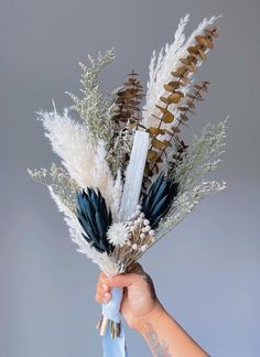 a person holding flowers in their hand