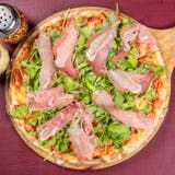 a pizza sitting on top of a wooden pan covered in meat and veggies