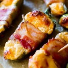 bacon wrapped in cheese and other toppings on skewers