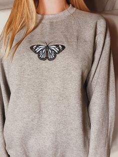 "Embroidered Butterfly Sweatshirt! -Embroidered on a cotton/polyester blend crewneck sweatshirt, this design is simple and minimalistic, perfect for every outfit! -Embroidery design measures 4.3\" x 4.3\". -See product pictures for shirt sizing chart. -All sweatshirts are handmade on an embroidery machine so there may be slight differences, but we only sell the shirts that meet our high-quality standards. -To maintain the quality of your shirt and the embroidery design make sure to wash with car Crew Neck Sweater With Custom Embroidery For Spring, Basic Long Sleeve Embroidered Sweatshirt, Embroidered Crew Neck Sweatshirt With Relaxed Fit, Basic Crew Neck Sweatshirt With Embroidered Graphics, Custom Embroidered Crew Neck Sweater In Relaxed Fit, Basic Embroidered Long Sleeve Sweatshirt, Gray Crew Neck Sweater With Embroidered Logo, Relaxed Fit Crew Neck Sweater With Custom Embroidery, Embroidered Crew Neck Sweatshirt In Relaxed Fit