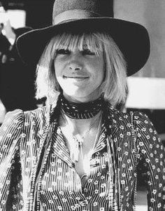 a woman with blonde hair wearing a hat