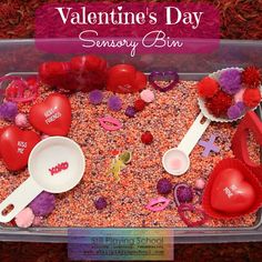 valentine's day memory bin filled with hearts and spoons for kids to play in