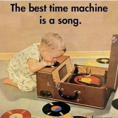 a little boy playing with an old record player