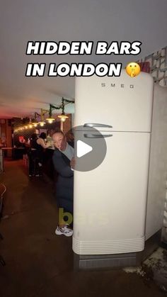 a man standing in front of a white refrigerator freezer with the words hidden bars in london on it