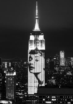 a black and white photo of a woman's face on the side of a building