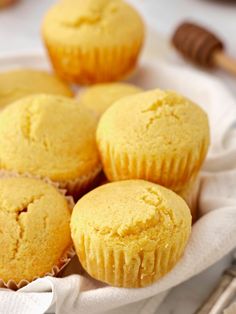 some yellow muffins are sitting in a basket