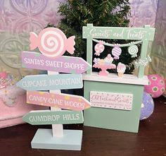 Gumdrop Hills Directions Sign. Mini Sweets & Treats Wood Booth. Pattern: Polka Dot. Pattern: Stripes. Color: Pink, Blue, White & Purple. Color: Green, White, Pink & Purple. Material: MDF.