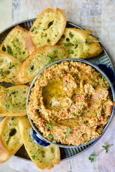 a plate with bread and dip on it