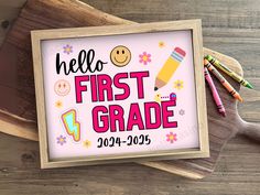 a sign that says hello first grade with some crayons and markers next to it