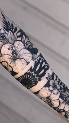 the arm is covered with black and white flowers