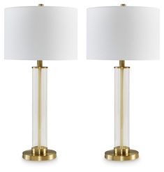 pair of modern glass and brass table lamps with white linen shades on each lamp base