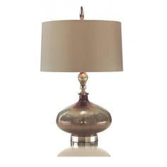 a table lamp with a beige shade on it