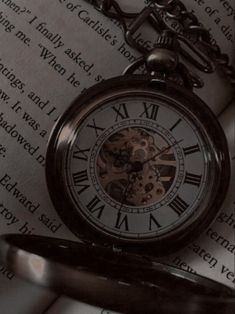 an old pocket watch sitting on top of a book with the time being 11 30