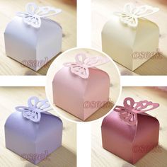 four different colored boxes with bows on the top and one has a bow at the bottom