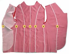 the back of a pink dress with white stripes and numbers on it's sides