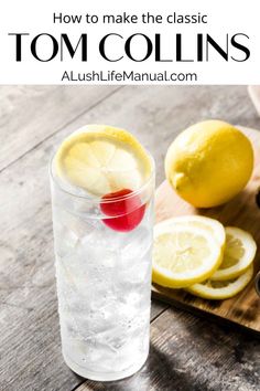 a glass filled with water and lemons on top of a wooden cutting board