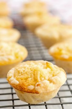 a muffin on a cooling rack with other muffins in the back ground