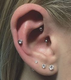 a woman with three different piercings on her ear