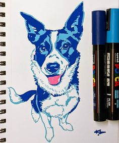 a drawing of a dog is shown on a notepad next to markers and pens