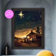 a nativity scene with the birth of jesus framed in a dark wood frame on a wall