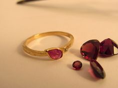 If you want to pay with PayPal, please contact me. Ring details: * The ring made from 14 karats solid yellow gold. * Ring width 0.05inch/ 1.5mm. * The house stone diameter 0.17x0.27inch/ 4.5x7mm. * Natural teardrop red Ruby. * 1 white diamond 0.01ct HVS1. Beautiful gold ring bezel set with a ruby and diamond. Rough but accurate. Handmade one of a kind. A perfect present for any occasion. Available in all sizes, color, gold and karat, and matte or shining finish. IF YOU WANT A CUSTOM ring please Dainty Yellow Gold Ruby Ring With Rose Cut Diamonds, Gold Ruby Ring With Bezel Setting For Promise, Gold Ruby Birthstone Ring With Rose Cut Diamonds, Beautiful Gold Rings, Star Ruby Ring, Ring Bezel, Gold Ring Sets, Custom Ring, Star Ruby