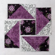 four pieces of purple and white quilted fabric with flowers on them, each piece has an interesting design