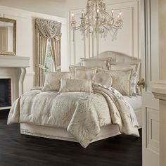 a large bed in a room with a chandelier