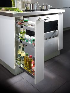 an open cabinet in the middle of a kitchen