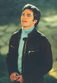 a man in a blue shirt and black jacket