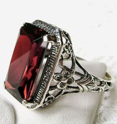 Garnet Ring (Choose Garnet CZ or Natural Garnet) AAR Design#64 Made To Order Inspired by the designs of the Victorian period; this gorgeous antique ring is made for you in 925 sterling silver. The sterling filigree ring is set with a flawless red garnet cubic zirconia (CZ) gemstone, or a Natural red garnet emerald-cut gemstone, very good color and clarity. The inside of the band is marked 925 for sterling. This rectangle cut gem is 15mm (about 5/8") x 9mm (3/8"). The ring sits 7mm off the finger Art Nouveau Ring, Sterling Silver Garnet Ring, Antique Filigree, Garnet Red, Vintage Style Jewellery, Sterling Silver Filigree, Lovely Ring, Filigree Ring, Cz Ring