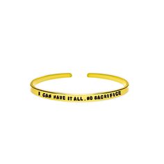 a gold cuff bracelet that says nothing is impossible