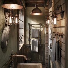 the bathroom is decorated in rustic style with copper fixtures and lights on the wall above the sink