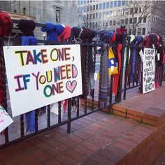 there are many signs on the fence that say take one, if you need one