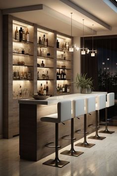 a bar with stools and bottles on the shelves in front of it at night