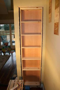 an empty book shelf in the corner of a room