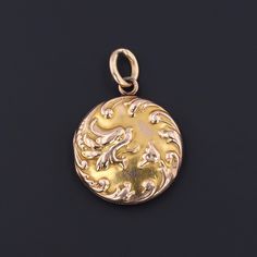 "A charming Art Nouveau era locket (circa 1910) with alluring repousse flowers and a feisty dragon! The locket is solid 10k gold and has the initials \"FPB\" carved on the back. It opens and closes securely and has one of the original frames and a covering used to hold a photo. The locket measures 1.4 inches from top to bottom by 1 inch wide, and it is in good condition with some minor wear (visible in the photos). We have many other fantastic offerings of antique and vintage jewelry posted on o Art Nouveau Engraved Pendant Jewelry, Art Nouveau Engraved Yellow Gold Jewelry, Engraved Yellow Gold Art Nouveau Jewelry, Gold Engraved Art Nouveau Jewelry, Art Nouveau Engraved Gold Jewelry, Ornate 14k Gold Medallion Jewelry, Gold Art Nouveau Jewelry Stamped 14k, Art Nouveau 14k Stamped Gold Jewelry, Art Nouveau Locket