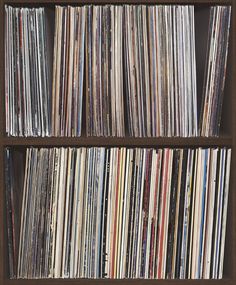 an old record shelf filled with various records