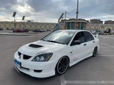 a white car parked in a parking lot