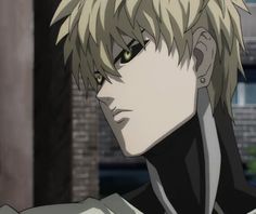 an anime character with blonde hair and green eyes looking at the camera while standing in front of a brick building